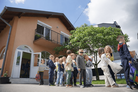Pupils lining up outside the Clever School building in Novi Sad