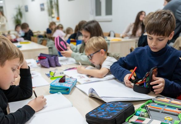 Pupils drawing and writing at their desks in a Clever School classroom