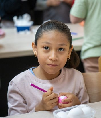 Pupil decorating an Easter egg in class