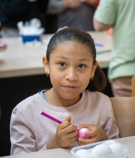 Pupil decorating an Easter egg in class