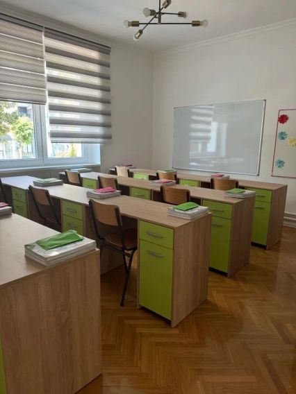 Bright classroom with green desks at Clever School in Novi Sad